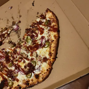 a half eaten pizza in a box