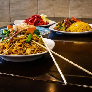 a plate of noodles and chopsticks