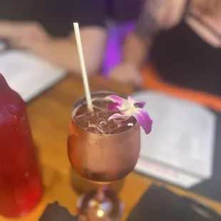 a close up of a drink in a glass on a table