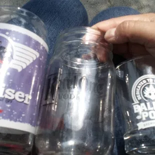 a hand holding two empty bottles