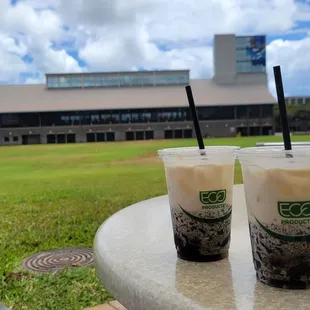 Enjoying 2 Iced Cloud Coffee Drinks in front of A building.