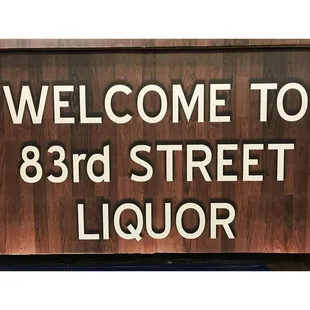 a sign that reads welcome to 83rd street liquor