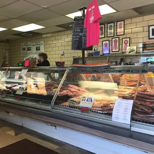 a deli counter with a variety of donuts