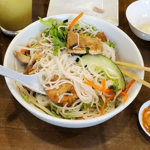 a bowl of noodles with meat and vegetables