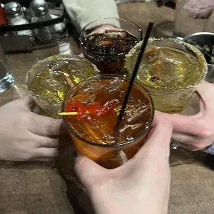 a group of people toasting with drinks