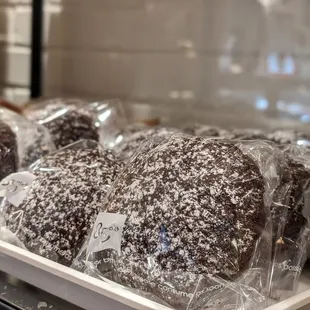 a tray of chocolate donuts