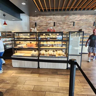 people walking past the bakery counter