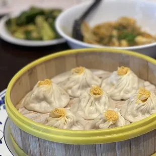 a bowl of dumplings and a bowl of broccoli