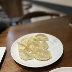 a plate of dumplings and a donut