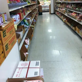 a grocery aisle with boxes of food