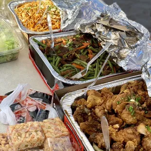 Full trays of Chow Mien, Green Beans Beef, and Black Pepper Chicken