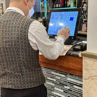 Server entering our dim sum order