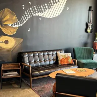 a living room with a piano mural