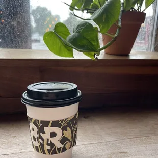 Latte and a nice plant (pothos?)