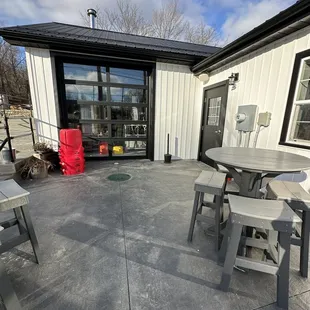 a patio with tables and chairs