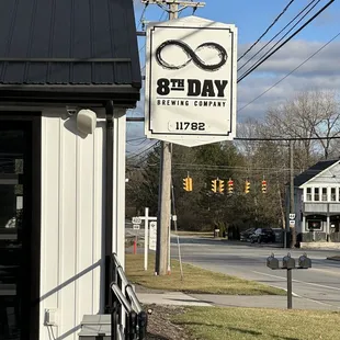 a sign for 8th day brewing