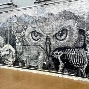 a mural of animals and skeletons