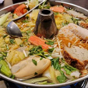 a bowl of soup with meat and vegetables