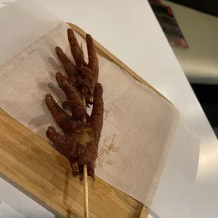 a skewer of food on a wooden tray