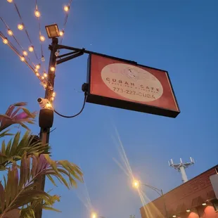 a street sign with string lights