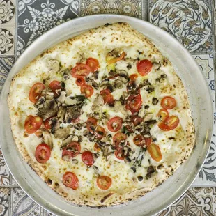 a pizza with tomatoes and mushrooms