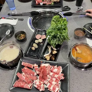 Hot pot with Tom yum broth and heathy herb broth  Korean barbecue
