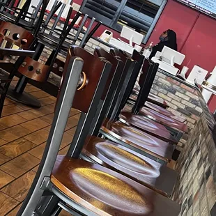 Bored cashier busy watching breaking news