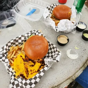 a burger and fries on a picnic table