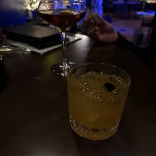 Ameretto Sour in the front, Manhattan in the background.