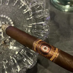 a cigar in a glass ashtray