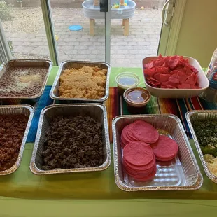 Rice, beans , carne asada , pastor , salsa, toppings , tortillas and chips