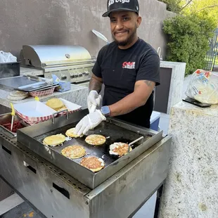 Roman cooking up delicious tacos