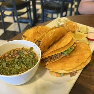 a plate of tacos and a bowl of salsa