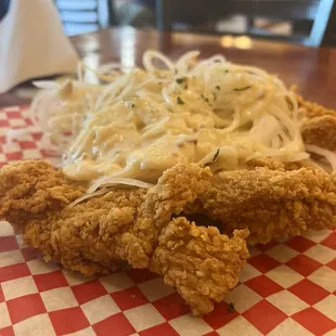 a plate of fried chicken and noodles