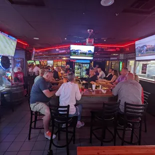 a group of people sitting at a bar