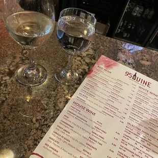 two glasses of wine and a menu
