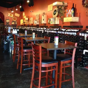 rows of tables and chairs in a wine shop