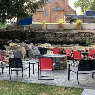 a patio with a fire pit