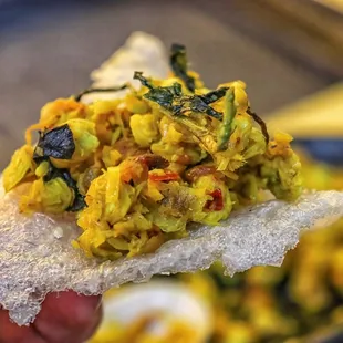 a hand holding a piece of food