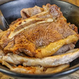 a large piece of meat in a black bowl