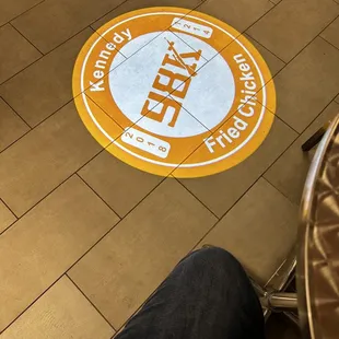 a logo on the floor of a restaurant