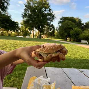 a person holding a sandwich