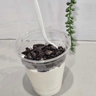 a cup of yogurt with a spoon in it