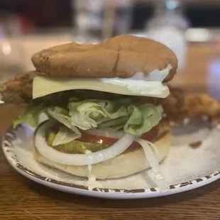 Fried chicken sandwich.  Sub raw onion for sautéed.