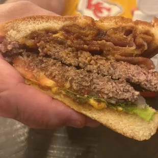 Western  BBQ Burger with bacon. All the trimmings and onion rings on top with BBQ sauce. Yummo!