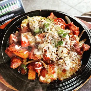 a plate of pasta with meat and cheese
