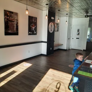 a toddler standing in front of a counter