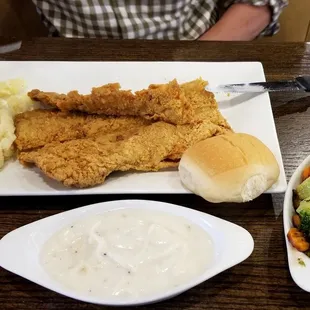 Chicken Fried Steak with a side of mashed potatoes and grilled mixed vegetables.