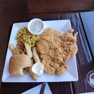 Chicken fried chicken with corn and french fries