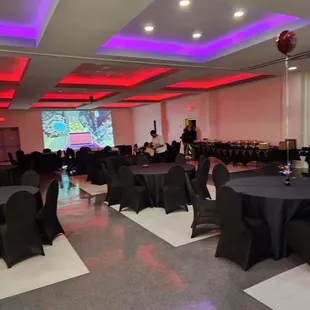 tables and chairs with black tablecloths